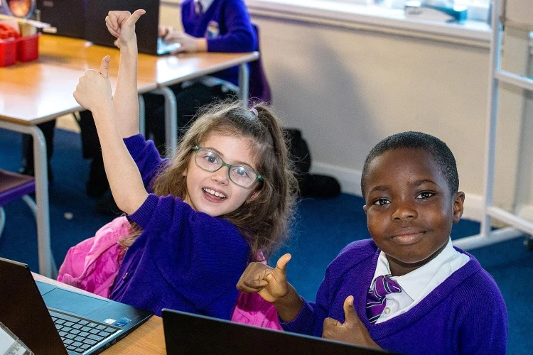 Two smiling children in a lesson
