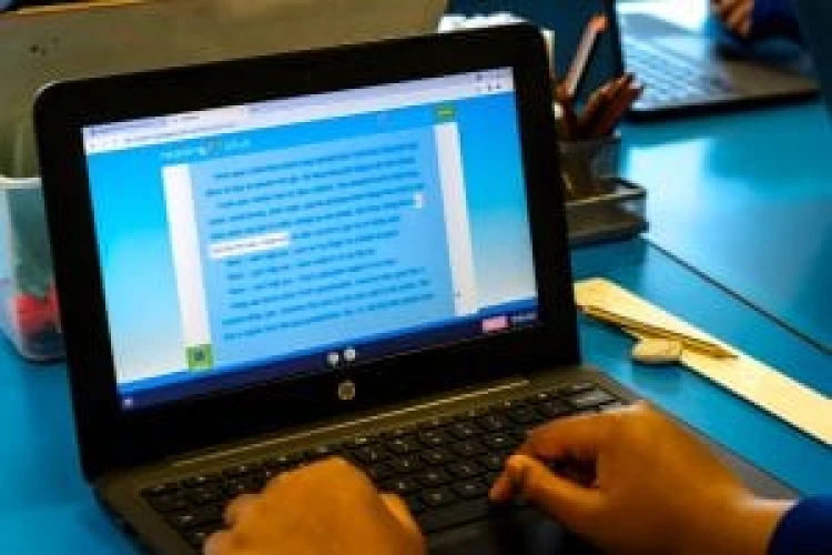 Pupil typing on a laptop