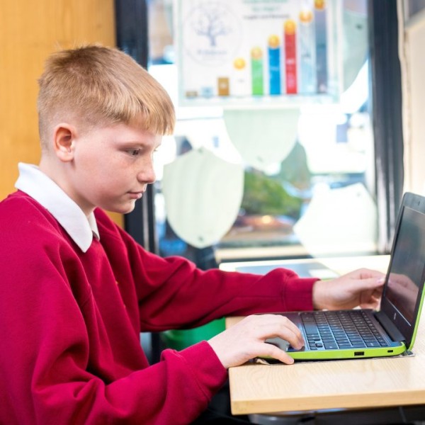 Child wearing a red top using Reading Plus