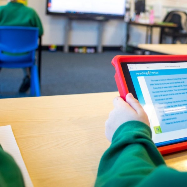 Child holding a red tablet