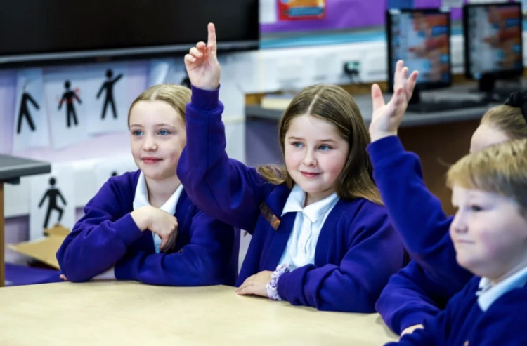 Children holding their hands in the air
