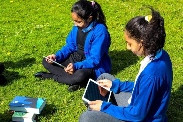 Children reading, sitting on grass