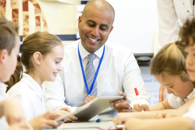 Children and a teacher using reading plus