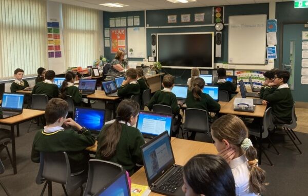 Children in a lesson using laptops