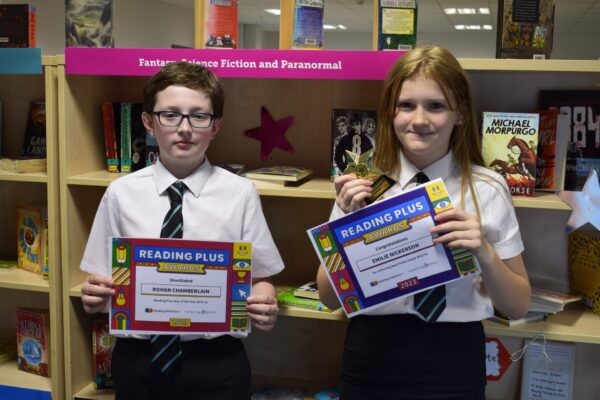 Two pupils holding their certificates
