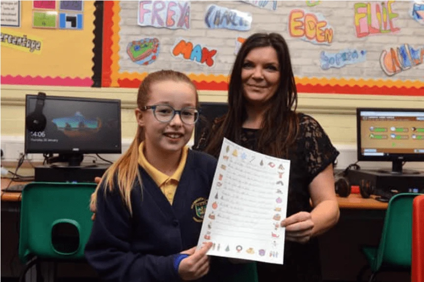 Student holding a certificate with a teacher