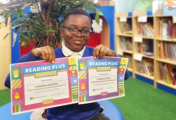 Pupil holding two certificates