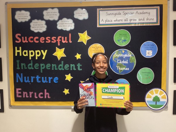 Sade holding a certificate