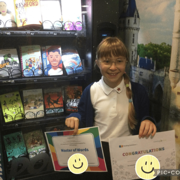 Child holding two certificates