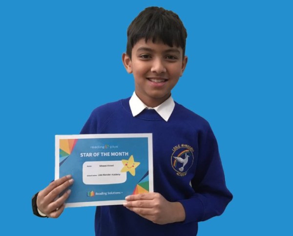 Pupil holding Star of the Month certificate 