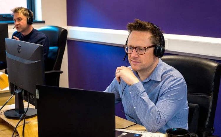 Person sitting a desk on a computer