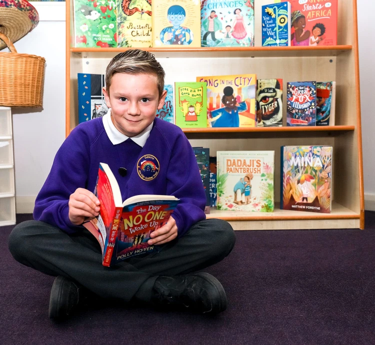 boy sitting with book in hand